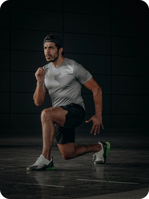 Athlete holding a lunge position in a training studio, representing the strength and conditioning products AppMatic Tech builds software for