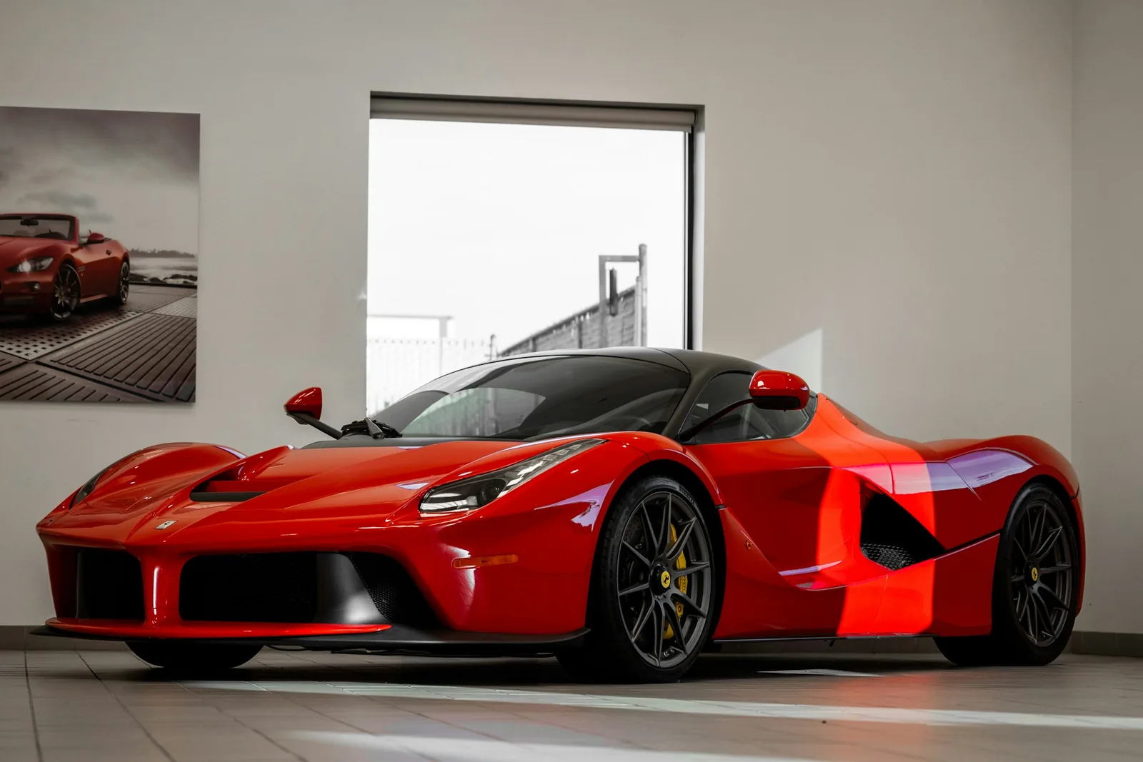 Red supercar parked in a showroom