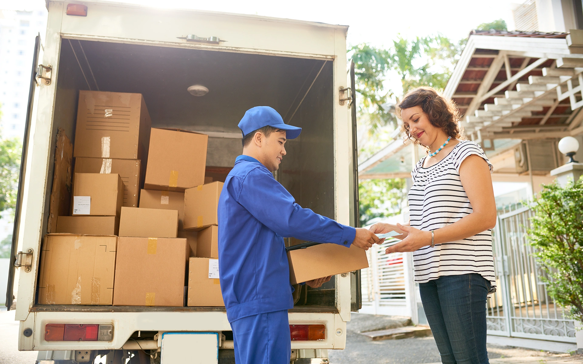 Driver handing a package to a customer at drop-off, the delivery completion moment captured as timestamped photo proof in the AppMatic Tech transport platform