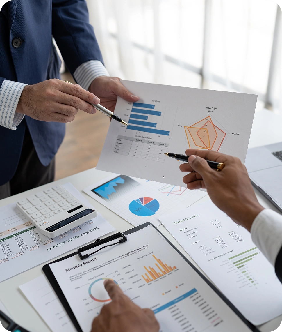 Financial analysts reviewing budget and performance reports, FinTech platform engineered by AppMatic Tech