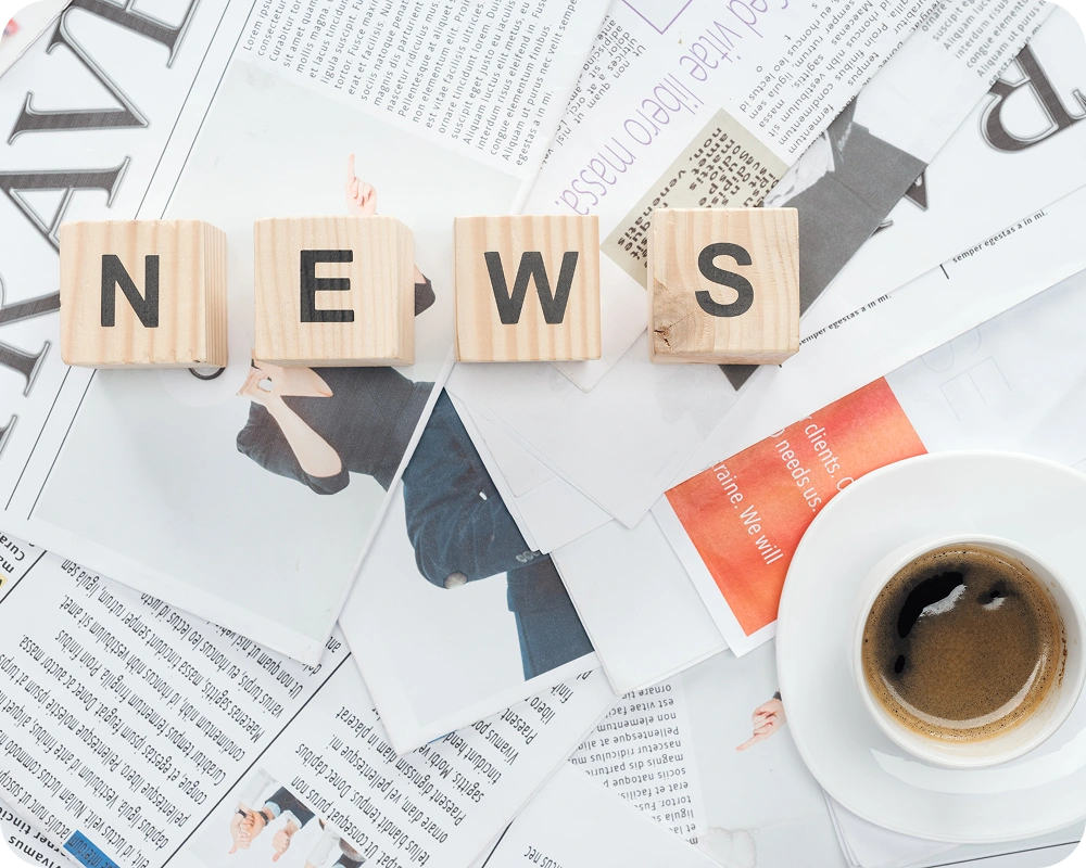 Newsroom desk with print and digital news content, publishing platform engineered by AppMatic Tech
