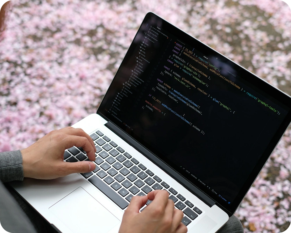 Developer coding a mobile app on a laptop